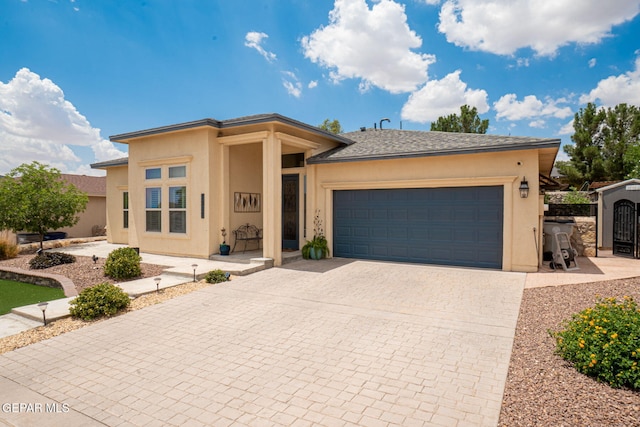 7317 Kiowa Creek Dr, El Paso, TX 79911 - view of front of house featuring stucco siding, decorative driveway, an attached garage, and a gate