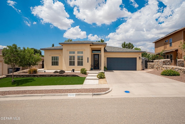 7317 Kiowa Creek Dr, El Paso, TX 79911 - view of front of home featuring an attached garage, stucco siding, driveway, and a front lawn