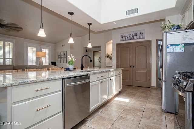 7317 Kiowa Creek Dr, El Paso, TX 79911 - kitchen featuring appliances with stainless steel finishes, white cabinetry, light tile patterned flooring, and a ceiling fan
