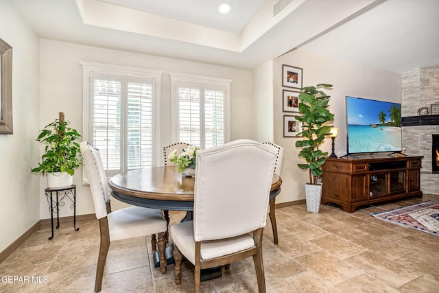 7317 Kiowa Creek Dr, El Paso, TX 79911 - dining area with a large fireplace and a raised ceiling