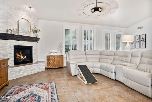 7317 Kiowa Creek Dr, El Paso, TX 79911 - living room featuring lofted ceiling, a stone fireplace, and a ceiling fan
