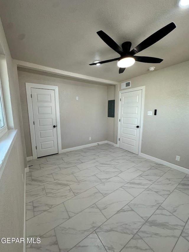 7216 Amethyst Rd, El Paso, TX 79915 - unfurnished room featuring a textured ceiling, electric panel, light marble finish floors, and ceiling fan