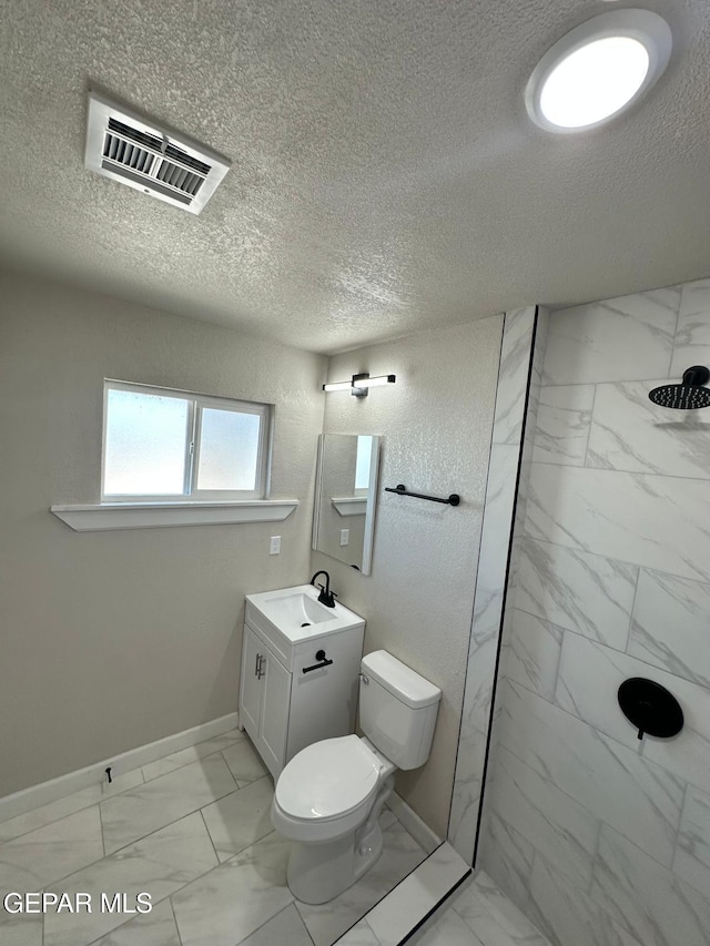 7216 Amethyst Rd, El Paso, TX 79915 - full bath featuring marble finish flooring, a marble finish shower, vanity, and a textured ceiling