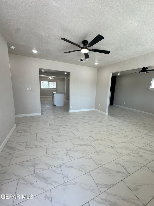 7216 Amethyst Rd, El Paso, TX 79915 - unfurnished room featuring ceiling fan, a textured ceiling, and light marble finish floors