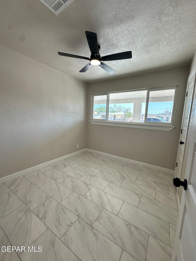7216 Amethyst Rd, El Paso, TX 79915 - spare room with light marble finish floors, ceiling fan, and a textured ceiling