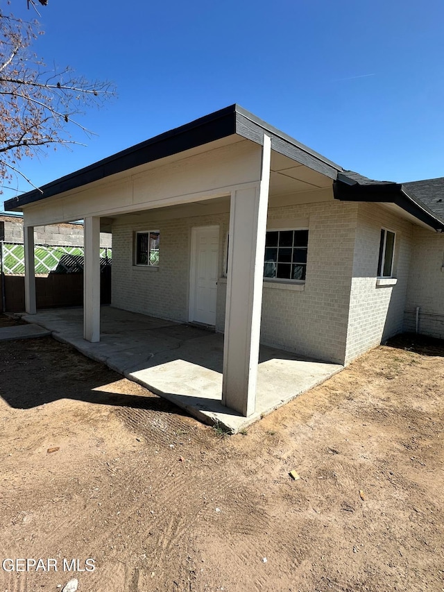7216 Amethyst Rd, El Paso, TX 79915 - view of property exterior featuring brick siding and a patio area