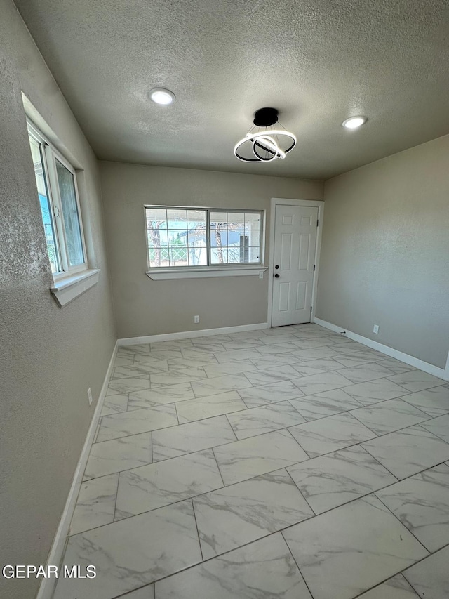 7216 Amethyst Rd, El Paso, TX 79915 - empty room featuring light marble finish flooring, a textured ceiling, and recessed lighting