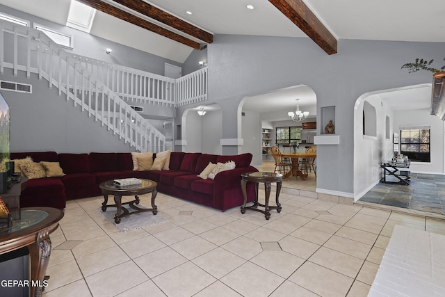 608 Paseo De Luna Ln, El Paso, TX 79912 - living room featuring light tile patterned floors, arched walkways, stairway, and a chandelier