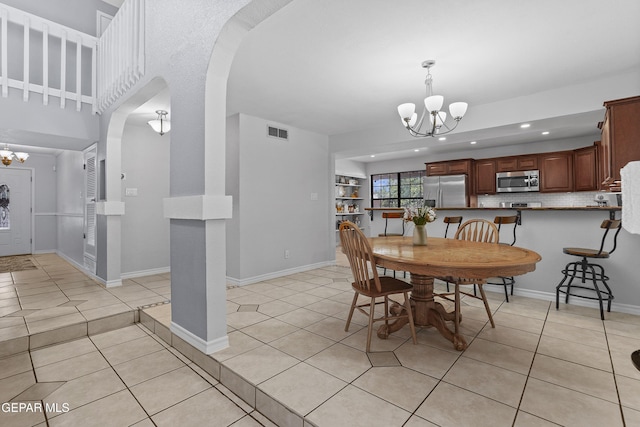 608 Paseo De Luna Ln, El Paso, TX 79912 - dining area with a chandelier, light tile patterned flooring, recessed lighting, and arched walkways