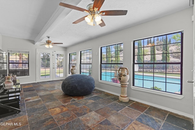608 Paseo De Luna Ln, El Paso, TX 79912 - sitting room featuring stone tile floors, a ceiling fan, plenty of natural light, and a textured ceiling
