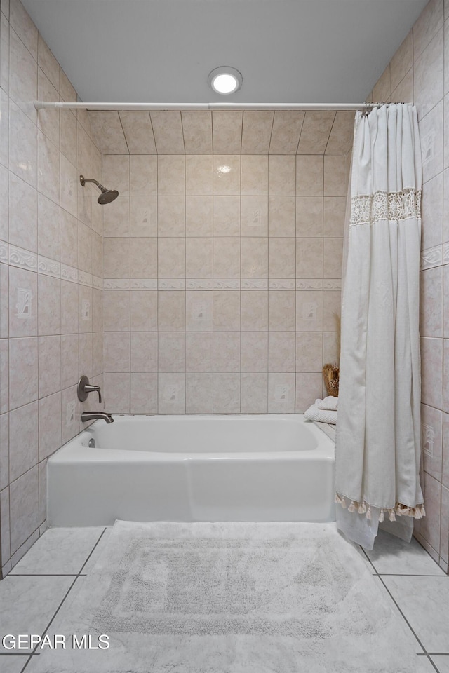 608 Paseo De Luna Ln, El Paso, TX 79912 - bathroom with shower / tub combo, tile walls, and tile patterned floors