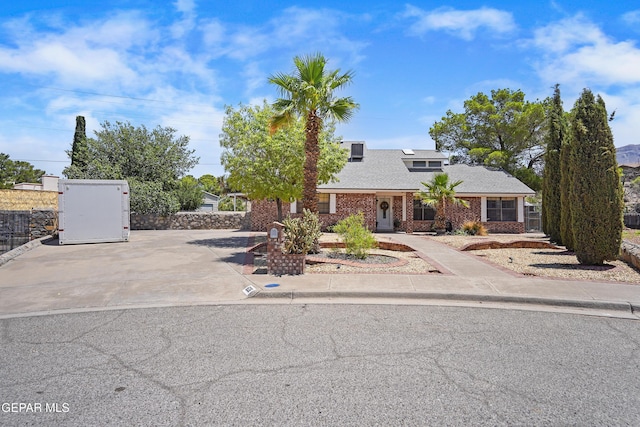 608 Paseo De Luna Ln, El Paso, TX 79912 - view of front of property featuring brick siding, concrete driveway, and a shingled roof