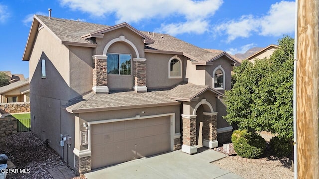 5020 Copper Ranch Ave, El Paso, TX 79934 - view of front of house featuring stone siding, stucco siding, a garage, driveway, and a shingled roof