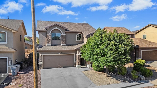 5020 Copper Ranch Ave, El Paso, TX 79934 - view of front of house featuring stucco siding, stone siding, a garage, driveway, and a residential view