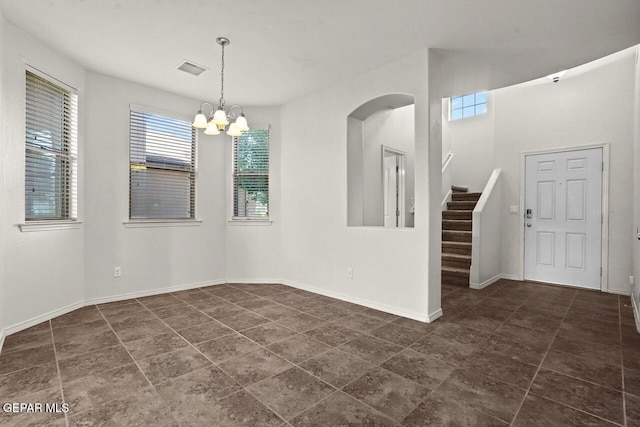 5020 Copper Ranch Ave, El Paso, TX 79934 - empty room with stairway, a chandelier, dark tile patterned flooring, and arched walkways