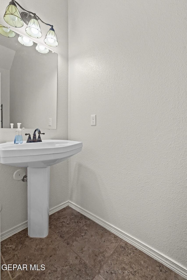 5020 Copper Ranch Ave, El Paso, TX 79934 - bathroom featuring baseboards and a sink