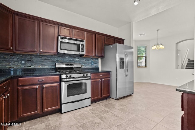 5020 Copper Ranch Ave, El Paso, TX 79934 - kitchen featuring appliances with stainless steel finishes, tasteful backsplash, a chandelier, pendant lighting, and dark stone countertops