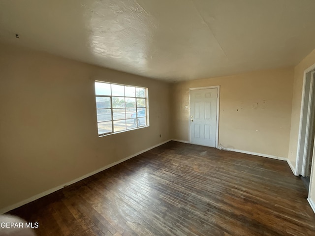 320 Edith Dr, El Paso, TX 79915 - unfurnished bedroom with dark wood finished floors and baseboards