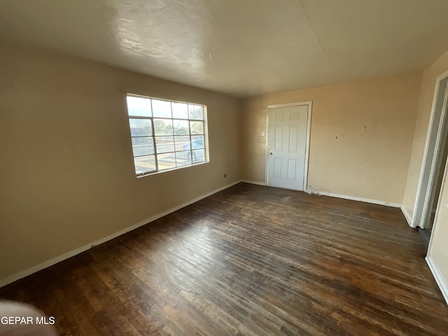 320 Edith Dr, El Paso, TX 79915 - unfurnished bedroom featuring dark wood-type flooring and baseboards
