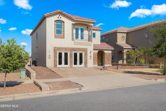 545 Lanner Dr, El Paso, TX 79928 - mediterranean / spanish home with french doors, stone siding, stucco siding, a tile roof, and driveway