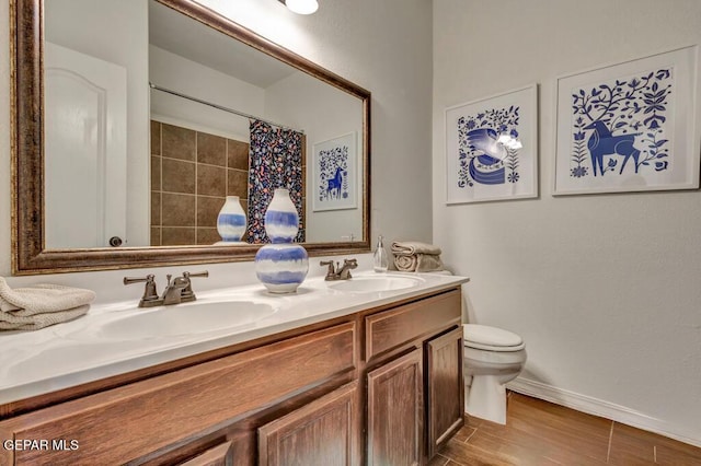 545 Lanner Dr, El Paso, TX 79928 - full bathroom featuring double vanity, curtained shower, and wood finished floors