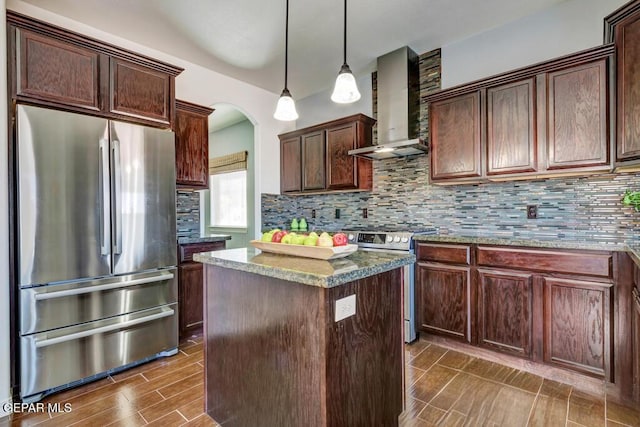 545 Lanner Dr, El Paso, TX 79928 - kitchen featuring stainless steel appliances, wall chimney range hood, a center island, and decorative backsplash
