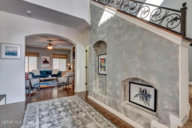 545 Lanner Dr, El Paso, TX 79928 - entryway with ceiling fan, arched walkways, wood tiled floors, and crown molding