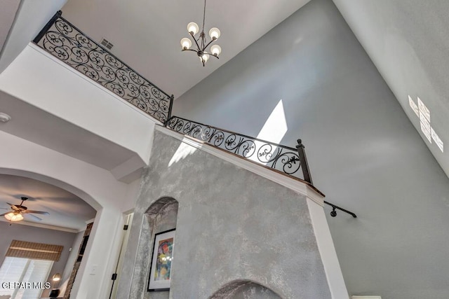 545 Lanner Dr, El Paso, TX 79928 - staircase featuring a high ceiling, a ceiling fan, arched walkways, and a chandelier