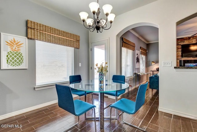 545 Lanner Dr, El Paso, TX 79928 - dining room featuring wood finish floors, arched walkways, a chandelier, and ornamental molding
