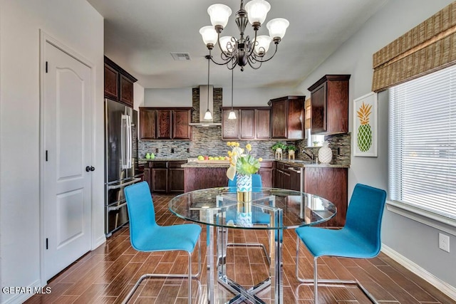 545 Lanner Dr, El Paso, TX 79928 - dining room with a chandelier and wood tiled floors
