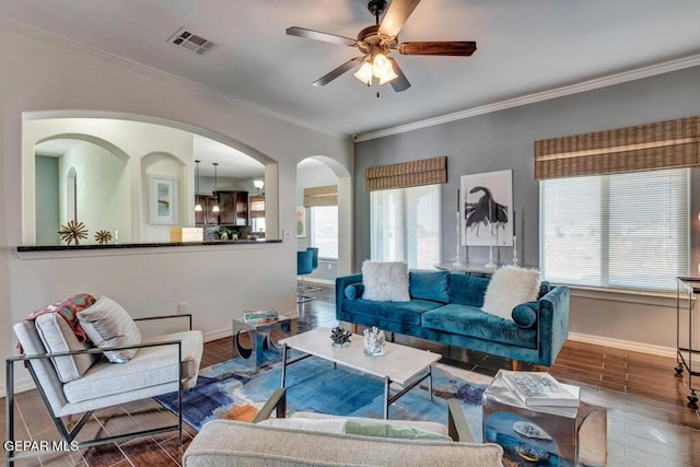 545 Lanner Dr, El Paso, TX 79928 - living room with wood finish floors, healthy amount of natural light, crown molding, and a ceiling fan
