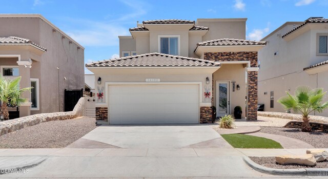 14192 Earl Chokiski, El Paso, TX 79938 - view of front of home with stone siding, an attached garage, stucco siding, and concrete driveway