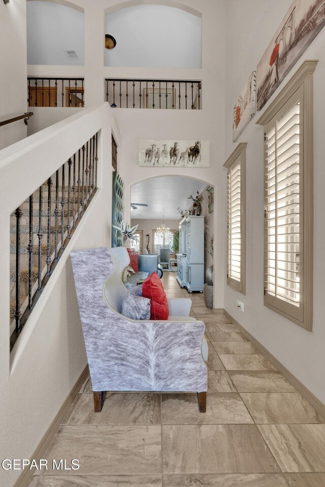 14192 Earl Chokiski, El Paso, TX 79938 - living area with a chandelier, arched walkways, a high ceiling, and marble finish flooring