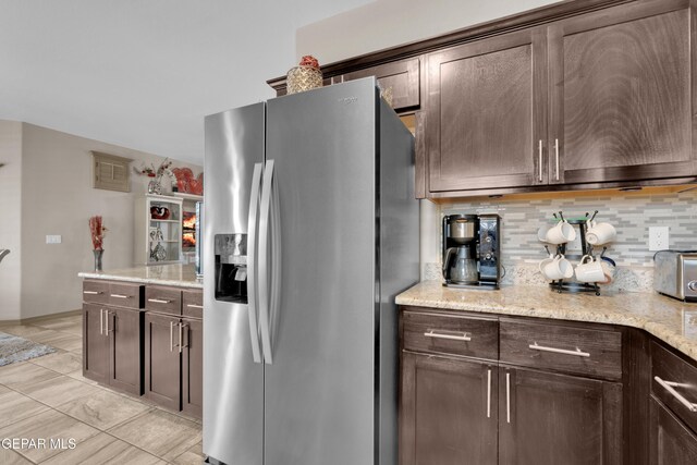 14192 Earl Chokiski, El Paso, TX 79938 - kitchen featuring stainless steel fridge with ice dispenser, tasteful backsplash, dark brown cabinetry, and light stone counters