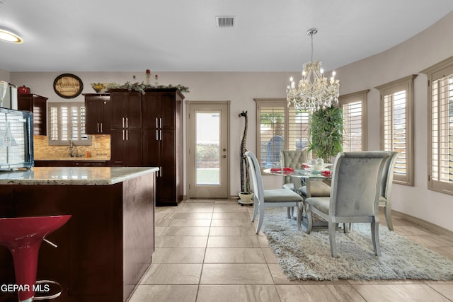 14192 Earl Chokiski, El Paso, TX 79938 - dining space featuring a chandelier and light tile patterned flooring