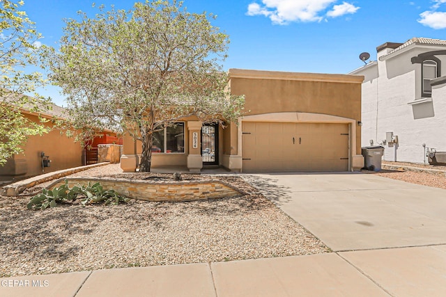 5024 Gold Ranch Ave, El Paso, TX 79934 - adobe home with an attached garage, driveway, and stucco siding