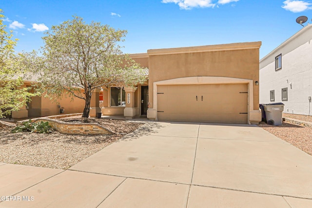 5024 Gold Ranch Ave, El Paso, TX 79934 - pueblo-style house featuring stucco siding, concrete driveway, and an attached garage