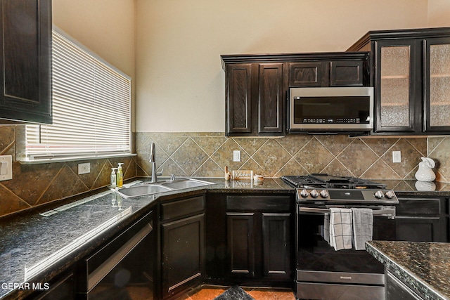 5024 Gold Ranch Ave, El Paso, TX 79934 - kitchen featuring stainless steel appliances, decorative backsplash, dark stone counters, and dark brown cabinetry