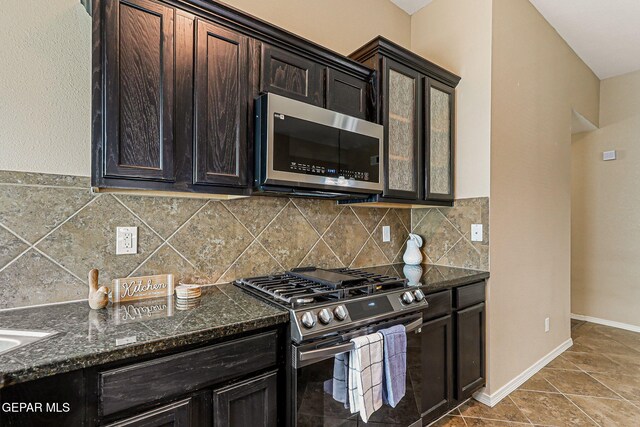 5024 Gold Ranch Ave, El Paso, TX 79934 - kitchen with appliances with stainless steel finishes, tasteful backsplash, dark stone countertops, and dark brown cabinetry