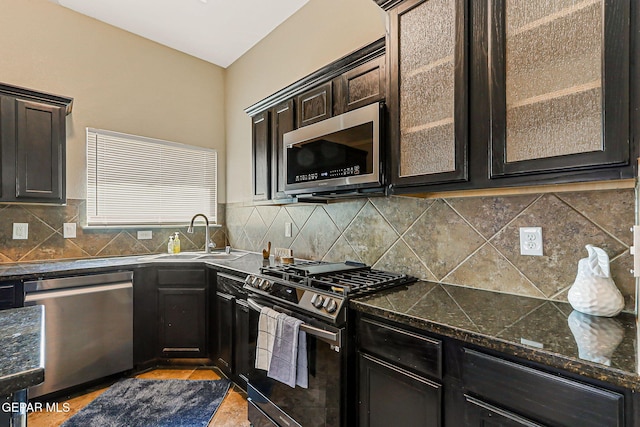 5024 Gold Ranch Ave, El Paso, TX 79934 - kitchen featuring stainless steel appliances, glass insert cabinets, backsplash, and dark brown cabinets
