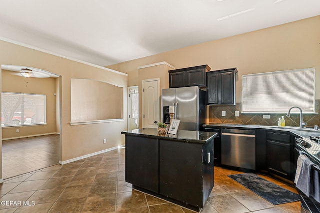 5024 Gold Ranch Ave, El Paso, TX 79934 - kitchen featuring stainless steel appliances, healthy amount of natural light, a kitchen island, and backsplash