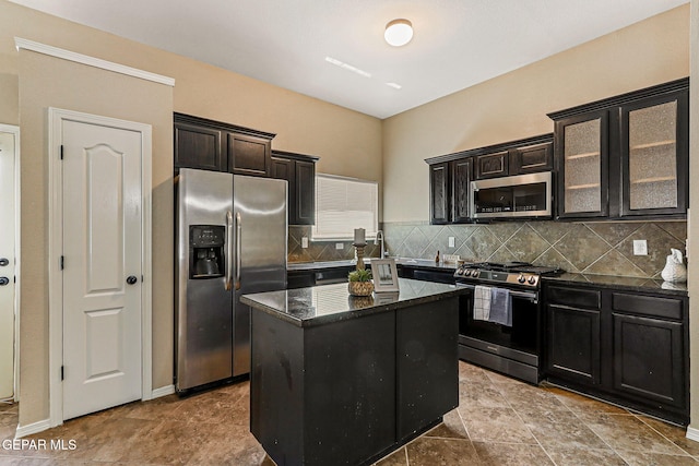 5024 Gold Ranch Ave, El Paso, TX 79934 - kitchen featuring appliances with stainless steel finishes, a center island, tasteful backsplash, dark stone counters, and glass insert cabinets