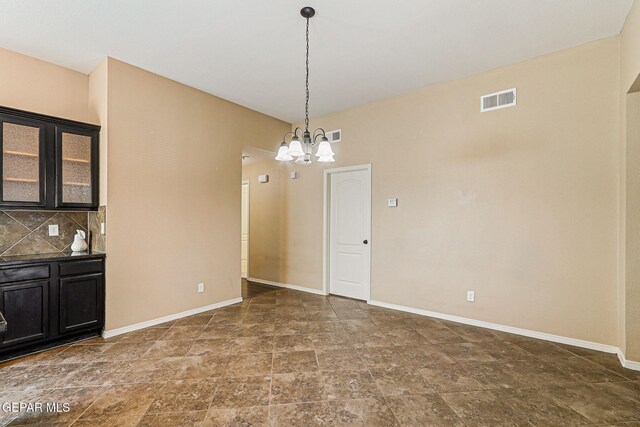 5024 Gold Ranch Ave, El Paso, TX 79934 - unfurnished dining area with stone finish floors and a chandelier