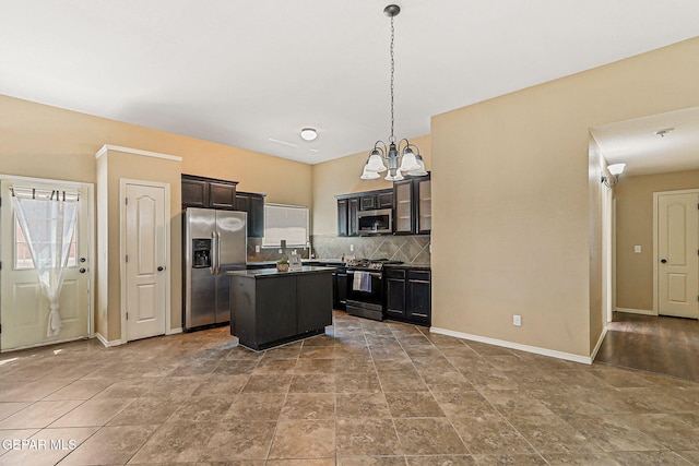 5024 Gold Ranch Ave, El Paso, TX 79934 - kitchen featuring stainless steel appliances, a chandelier, decorative backsplash, a center island, and dark countertops