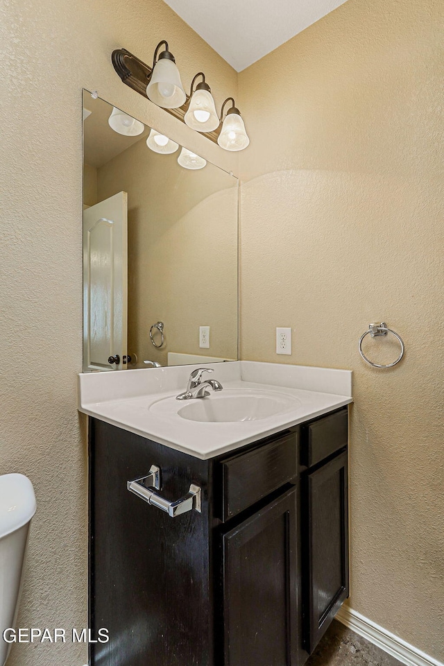 5024 Gold Ranch Ave, El Paso, TX 79934 - bathroom featuring vanity and a textured wall