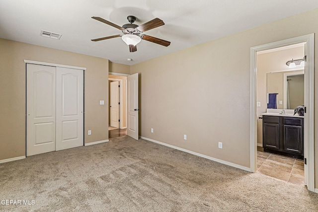 5024 Gold Ranch Ave, El Paso, TX 79934 - unfurnished bedroom featuring light carpet, a closet, ensuite bathroom, and ceiling fan