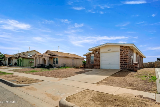 10980 Northampton St, El Paso, TX 79934 - ranch-style home with brick siding, driveway, and an attached garage