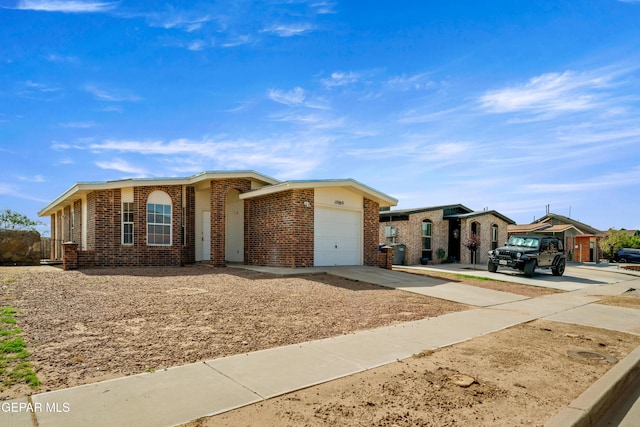 10980 Northampton St, El Paso, TX 79934 - single story home with driveway, an attached garage, and brick siding