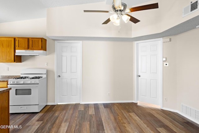 10980 Northampton St, El Paso, TX 79934 - kitchen with white range with gas cooktop, brown cabinetry, a ceiling fan, dark wood-style flooring, and under cabinet range hood