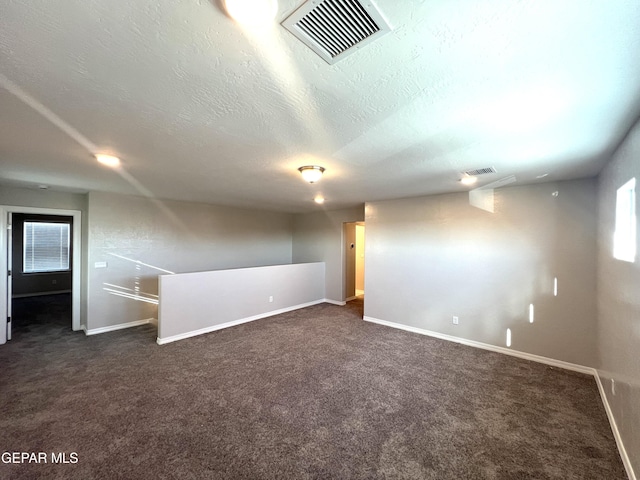 3720 Hill Top Place, El Paso, TX 79938 - empty room featuring dark colored carpet and a textured ceiling